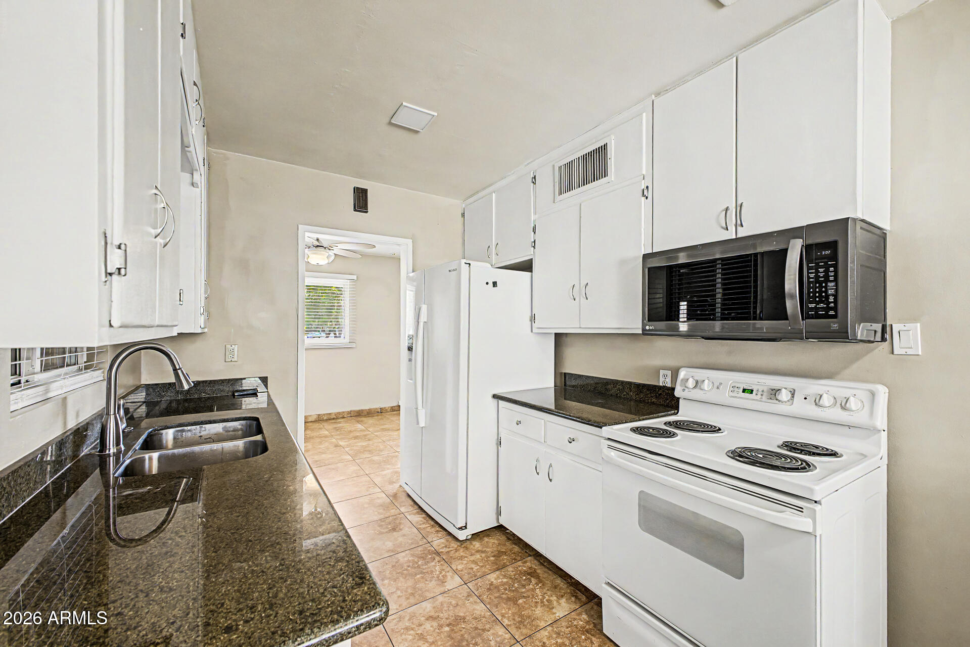 2022 East Monterey Way Phoenix, AZ 85016 - Photo 10 of 29 a kitchen with stainless steel appliances a stove a microwave and a refrigerator