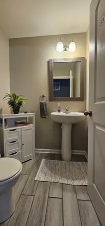 a bathroom with a sink toilet and mirror