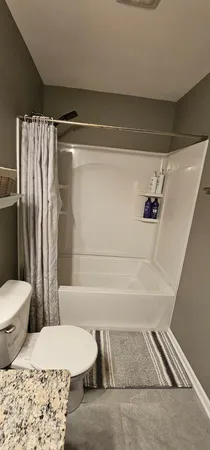 a bathroom with a toilet and a shower
