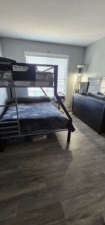 a bedroom with furniture and wooden floor