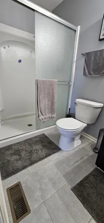 a bathroom with a toilet and a shower