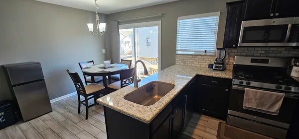 a kitchen with sink cabinets and appliances