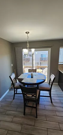 a view of a dining room with furniture wooden floor and chandelier