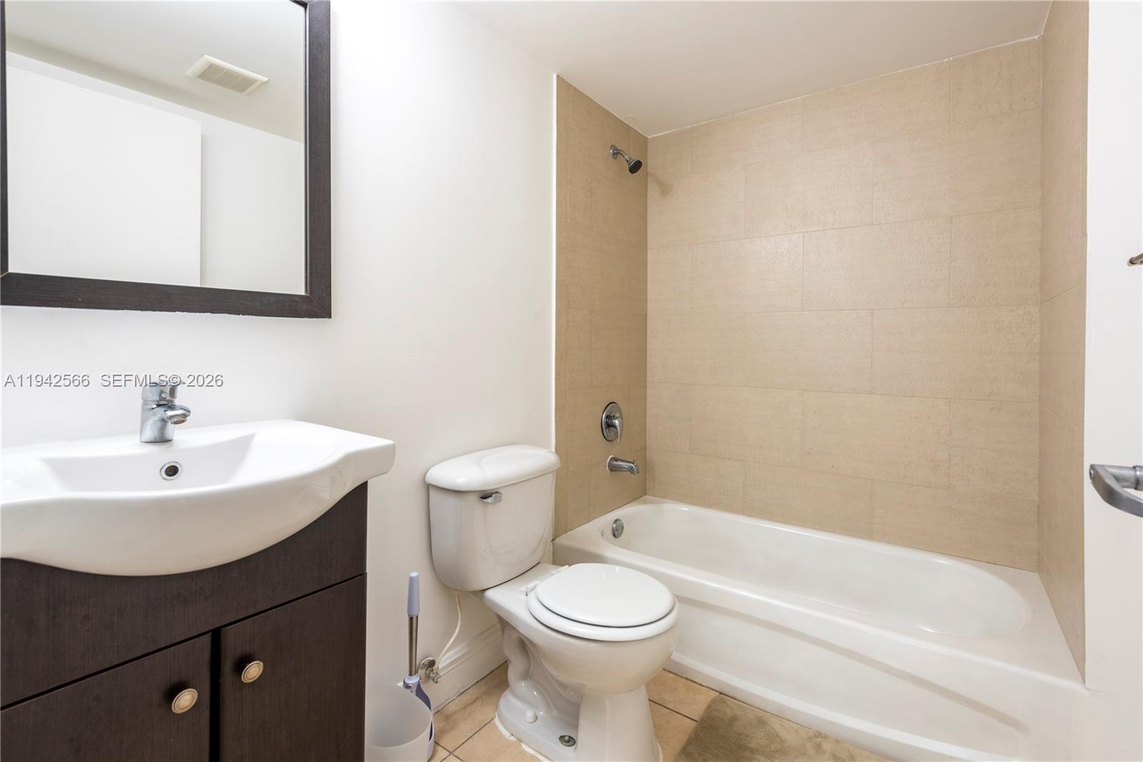 4147 Stirling Road, Unit 301 Dania Beach, FL 33314 - Photo 12 of 12 a bathroom with a sink a toilet and shower