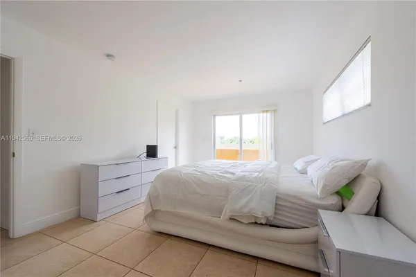 a bedroom with a bed and window