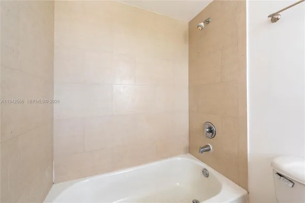 a bathroom with a white bath tub and a shower