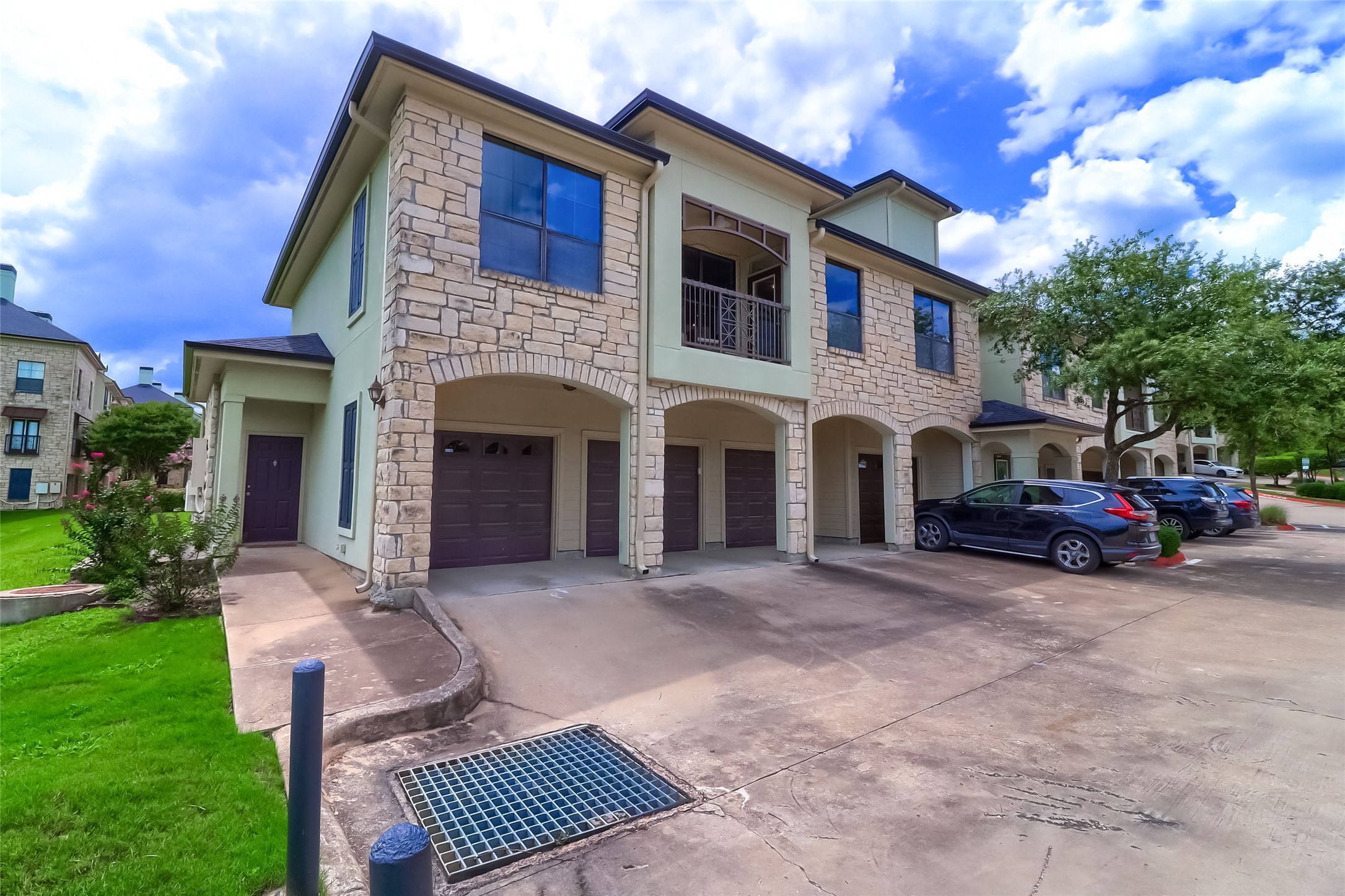 7701 Rialto Boulevard, Unit 1128 Austin, TX 78735 - Photo 29 of 35 a front view of a house with a garden