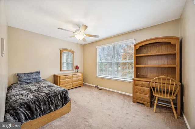 a bedroom with a bed a table and chair