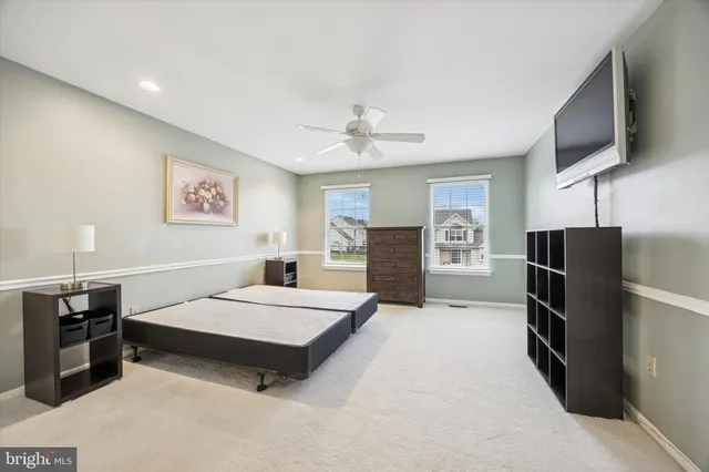 a bedroom with a bed furniture and a flat screen tv
