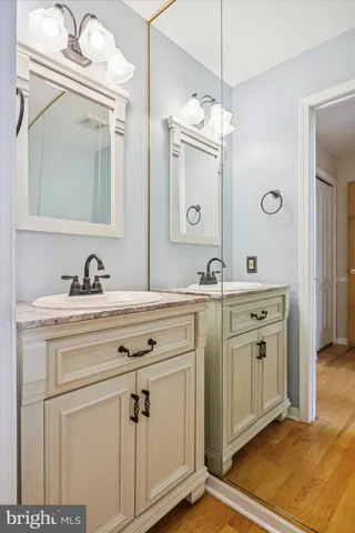 a bathroom with a sink vanity and a mirror