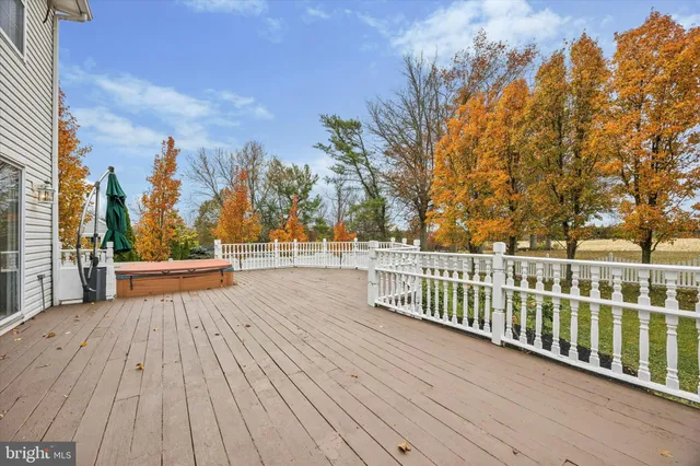 a view of a balcony with wooden floor and fence