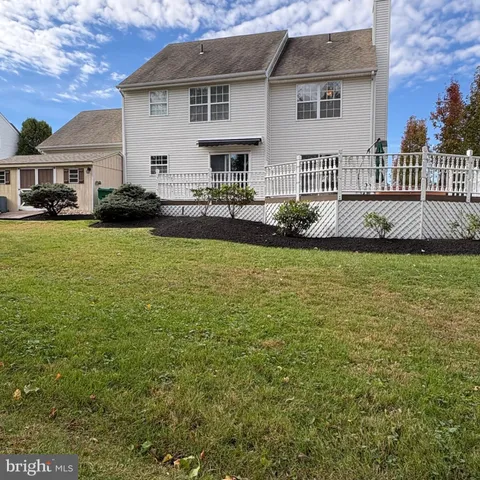 a front view of a house with swimming pool having outdoor seating