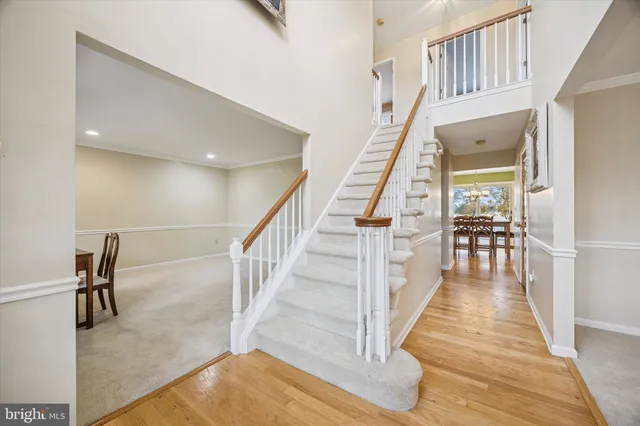 a view of staircase with lots of frames on wall and windows