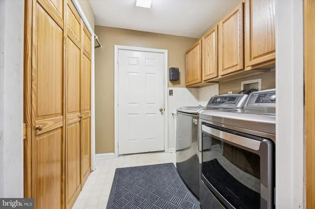 a kitchen with granite countertop a sink stove and cabinets