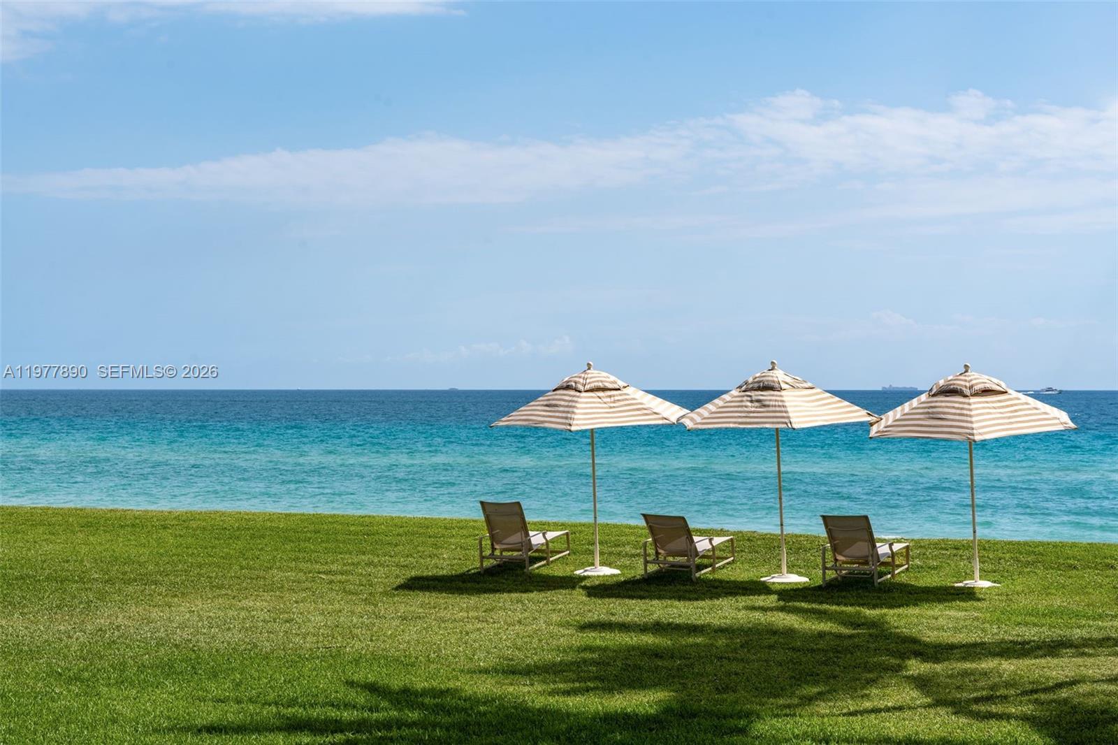 355 Ocean Boulevard Golden Beach, FL 33160 - Photo 2 of 18 a large pool with lawn chairs under an umbrella