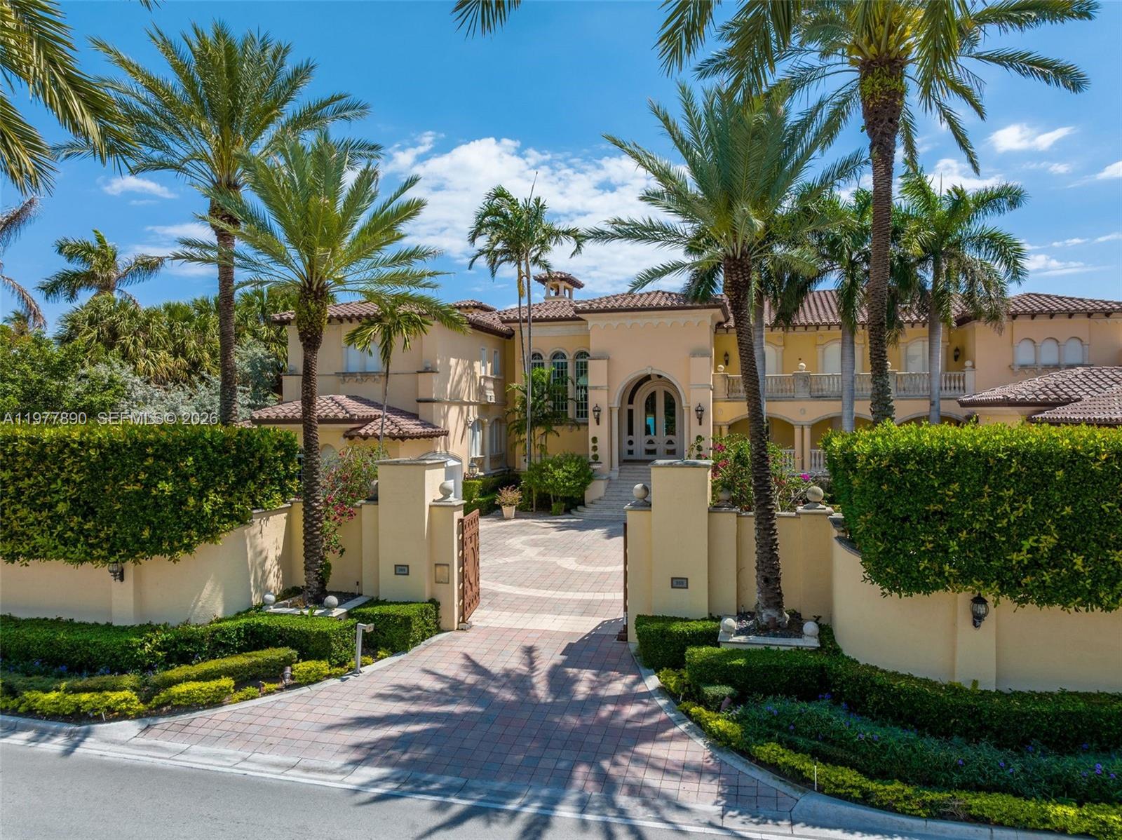 355 Ocean Boulevard Golden Beach, FL 33160 - Photo 9 of 18 a view of a white house with a yard and potted plants