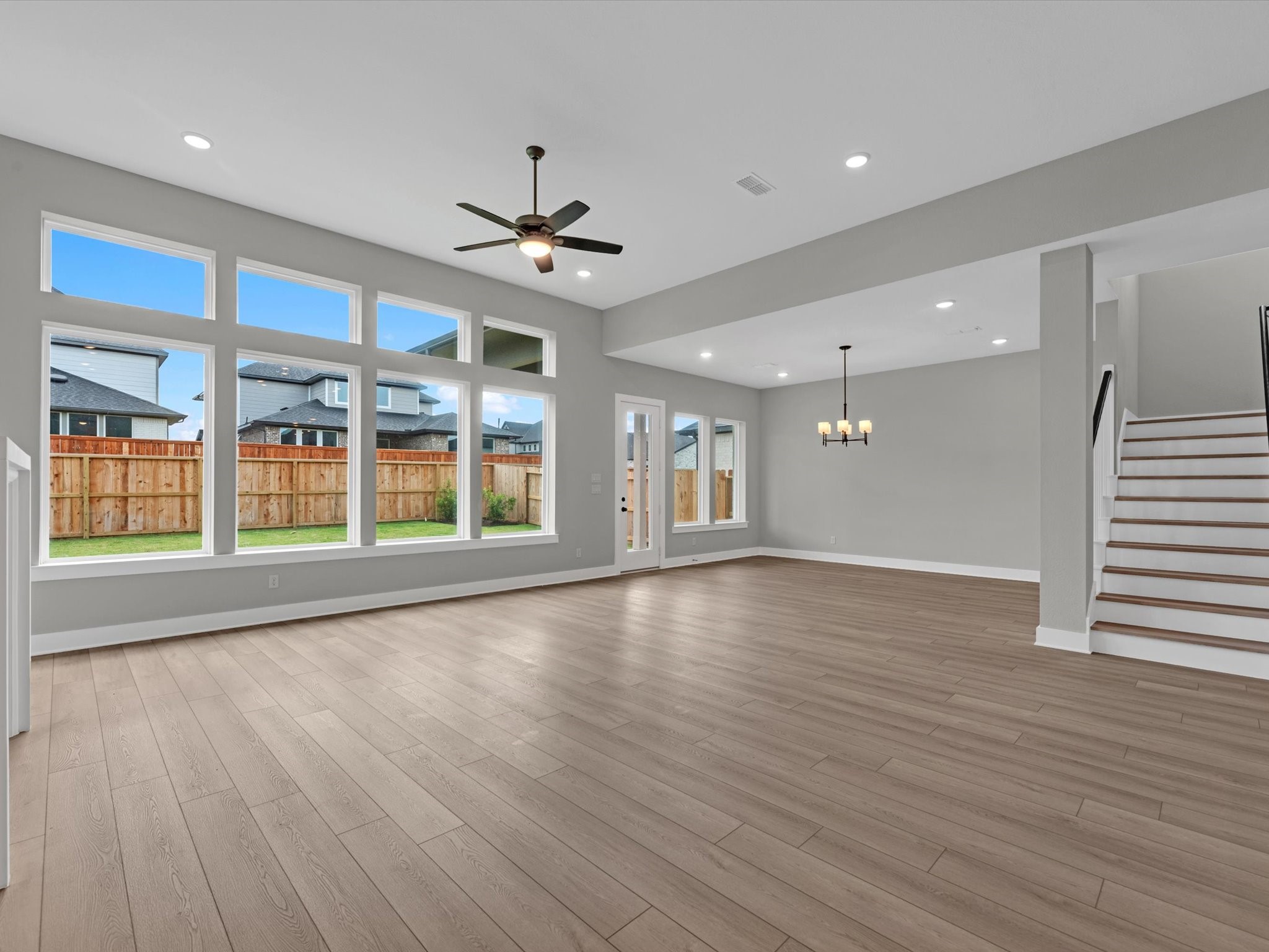 8123 Sunny Rdg Drive Fulshear, TX 77441 - Photo 7 of 42 a view of an empty room with wooden floor and a window