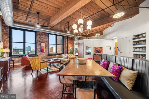 a outdoor dining area with furniture and wooden floor