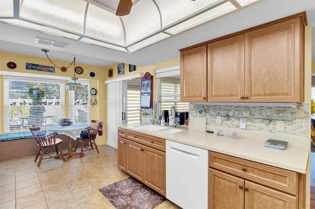 a large kitchen with stainless steel appliances kitchen island granite countertop a sink and cabinets