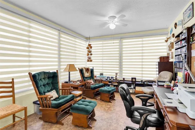 a dining room with furniture and a window