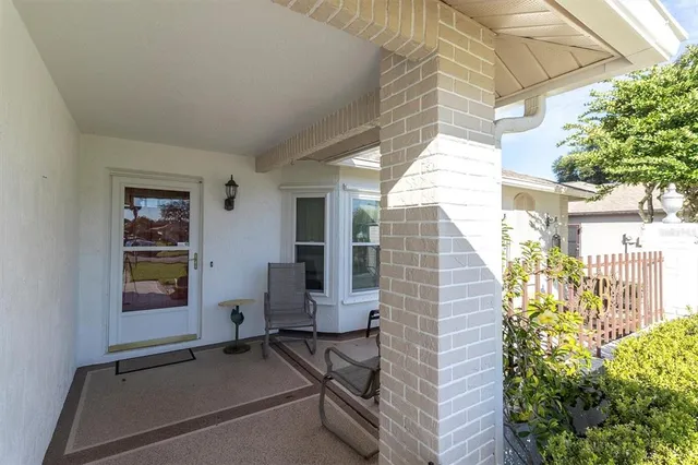 a view of a patio with table and chairs and potted plants