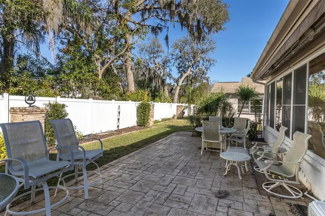 a view of a patio with table and chairs and potted plants