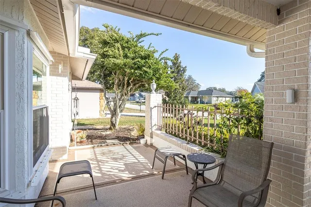 a living room with furniture a lamp a rug and a large window