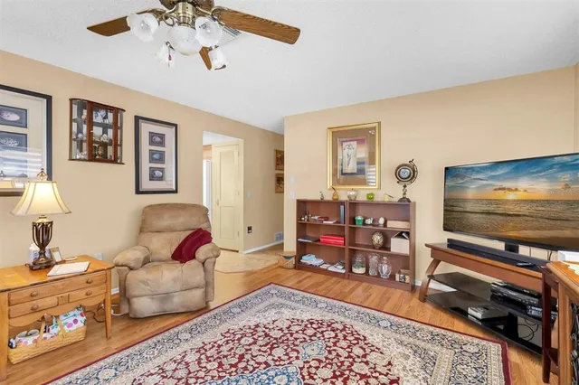 a living room with furniture a flat screen tv and a window