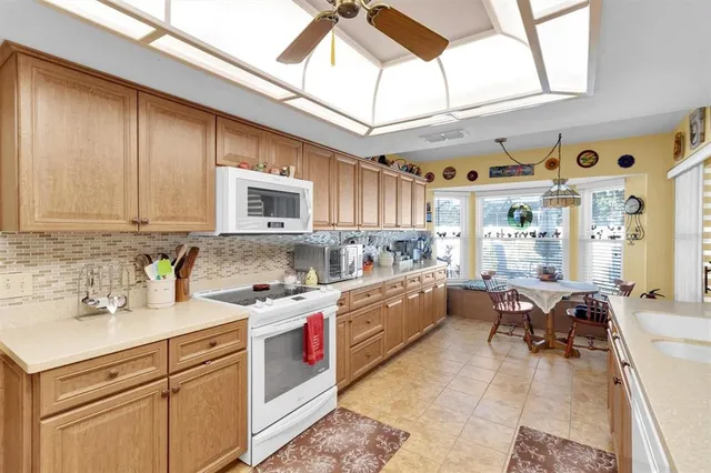 a kitchen with a sink cabinets and window