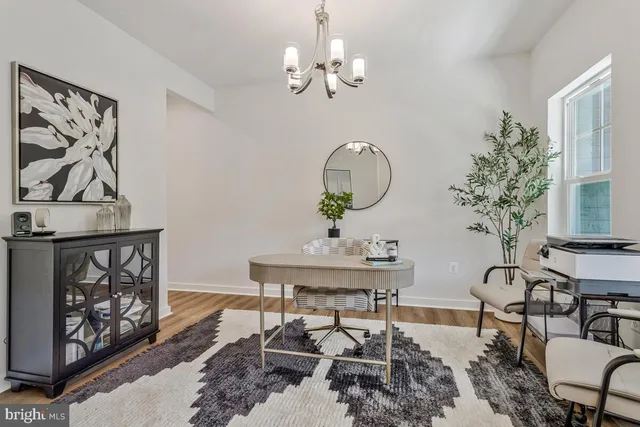 a living room with furniture a chandelier and a mirror