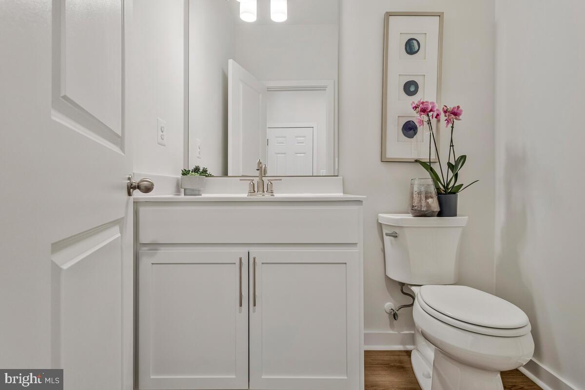 1302 Spruce Street Shady Side, MD 20764 - Photo 19 of 43 a bathroom with a sink a toilet and a mirror