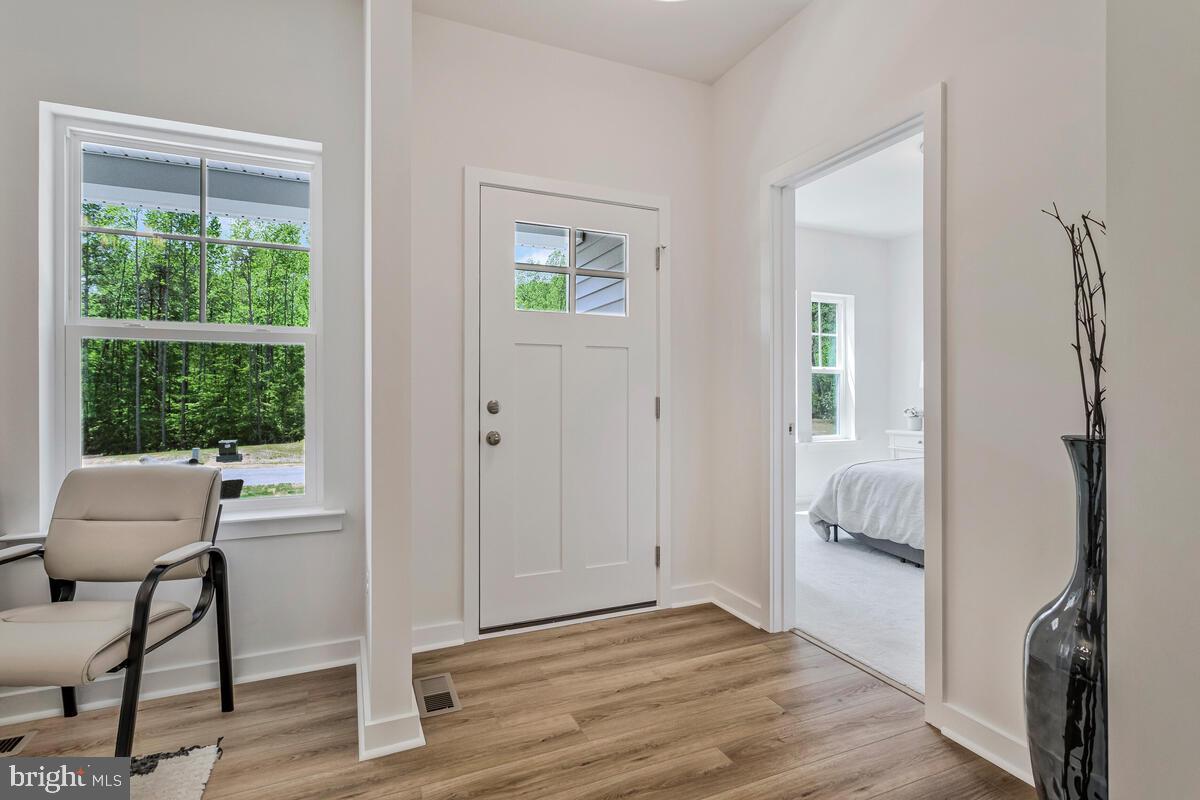 1302 Spruce Street Shady Side, MD 20764 - Photo 2 of 43 a view of an empty room with wooden floor and a window
