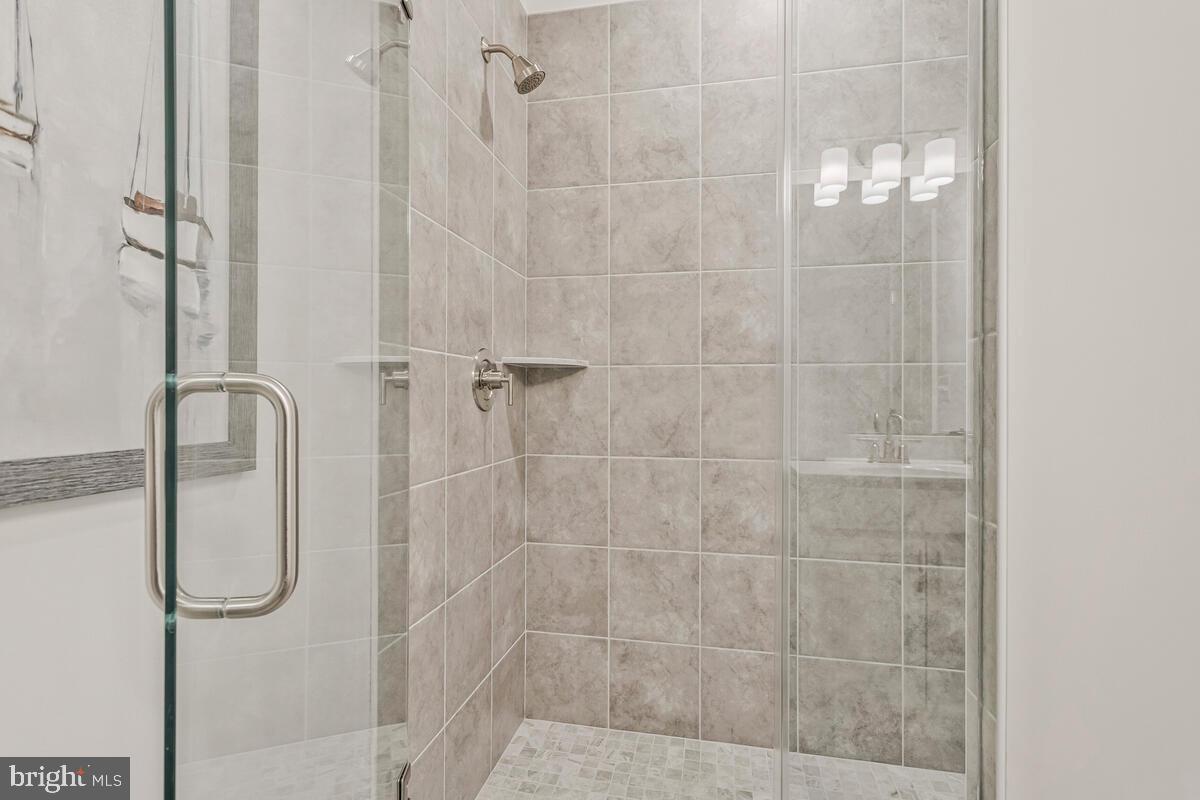 1302 Spruce Street Shady Side, MD 20764 - Photo 24 of 44 a bathroom with a glass shower door