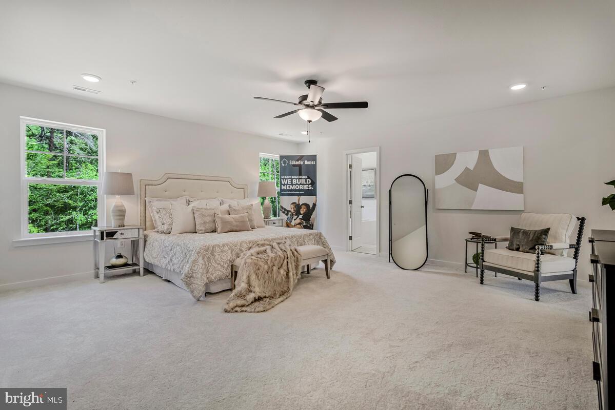 1302 Spruce Street Shady Side, MD 20764 - Photo 25 of 44 a bedroom with a bed a chandelier and a large window