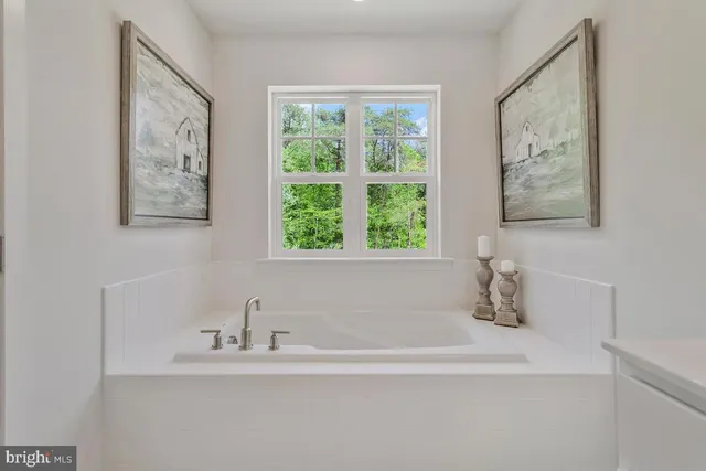 a white bath tub sitting next to a white sink