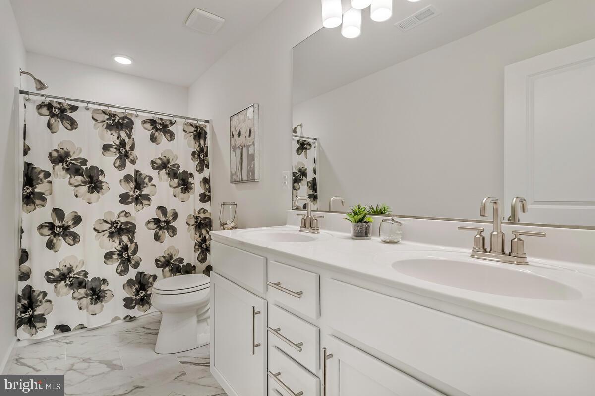 1302 Spruce Street Shady Side, MD 20764 - Photo 36 of 43 a bathroom with a sink toilet and shower