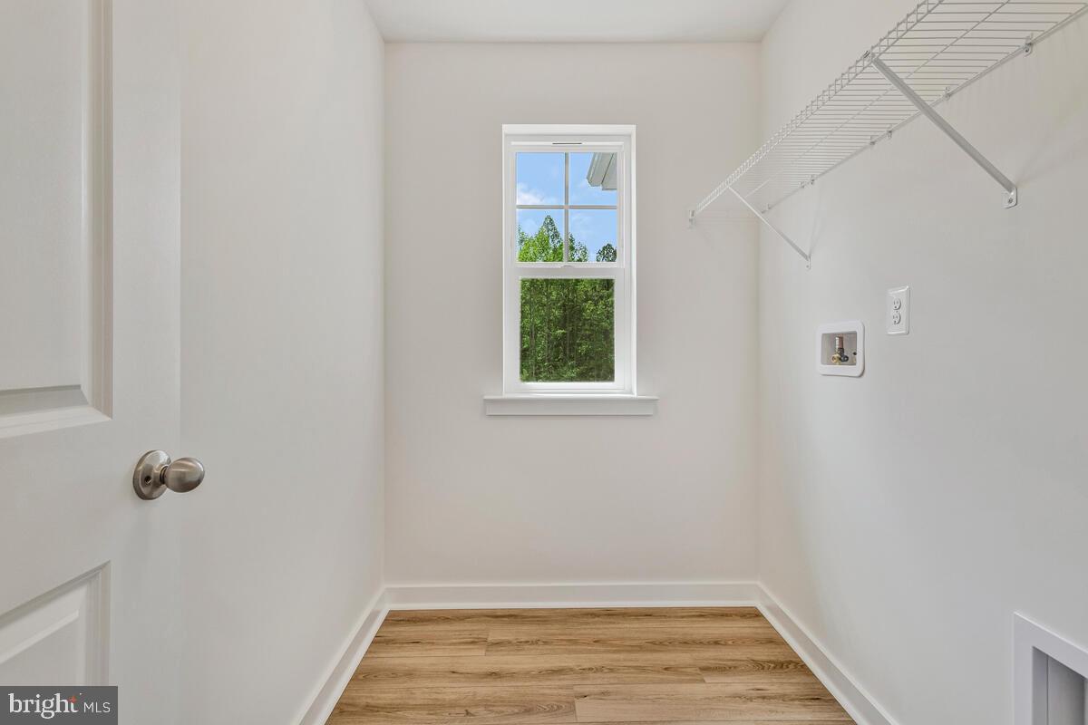 1302 Spruce Street Shady Side, MD 20764 - Photo 38 of 44 a view of a room with wooden floor and small window