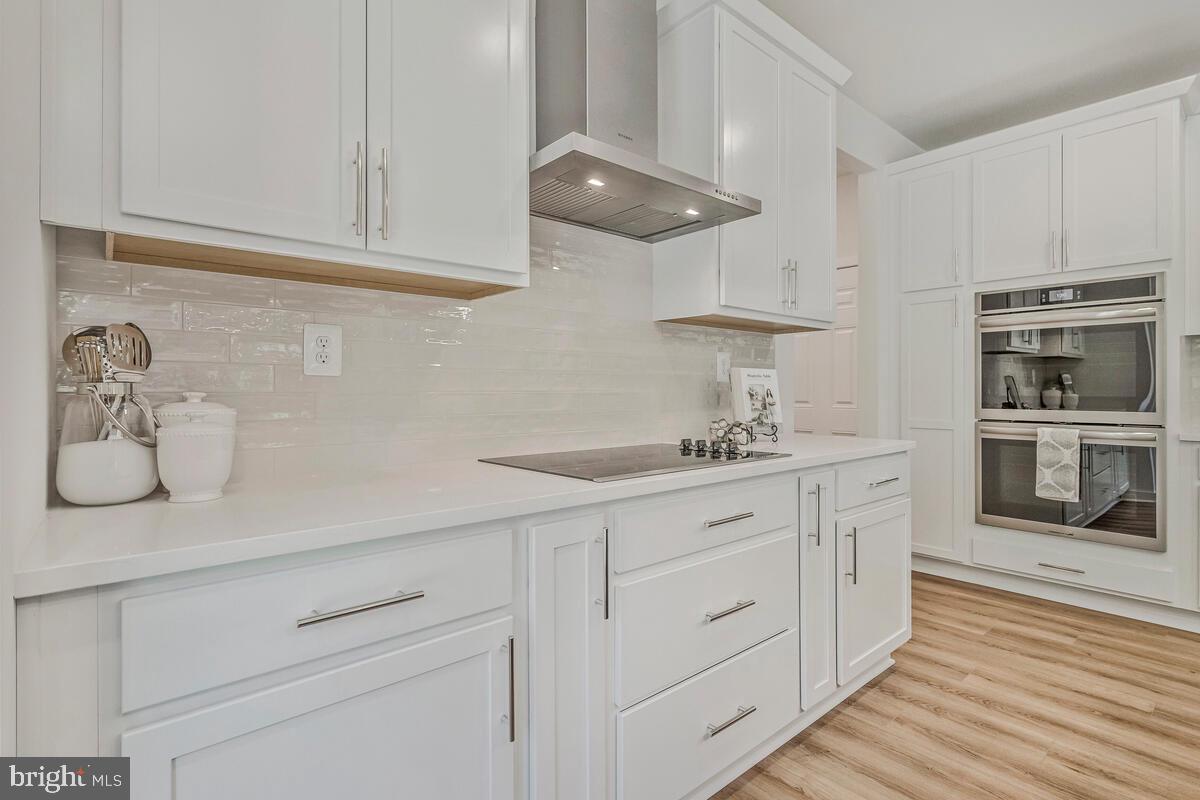 1302 Spruce Street Shady Side, MD 20764 - Photo 6 of 44 a kitchen with stainless steel appliances granite countertop a sink a stove and cabinets