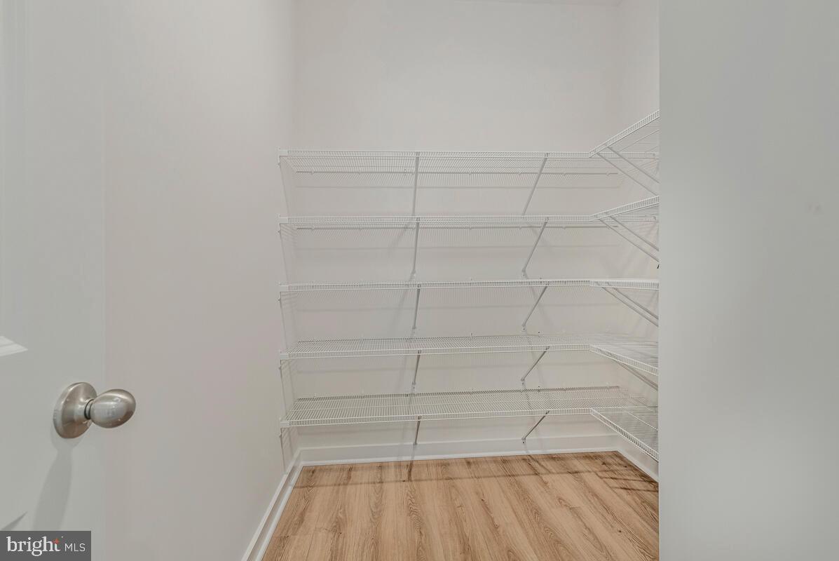 1302 Spruce Street Shady Side, MD 20764 - Photo 8 of 43 a view of a room with racks on the wall