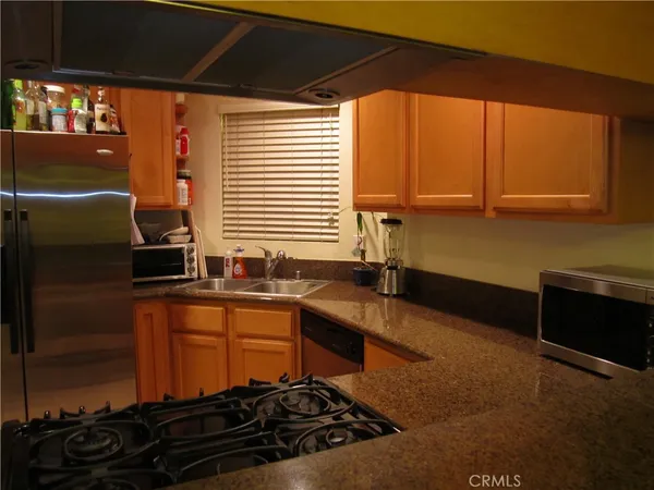 a kitchen that has a sink and a stove