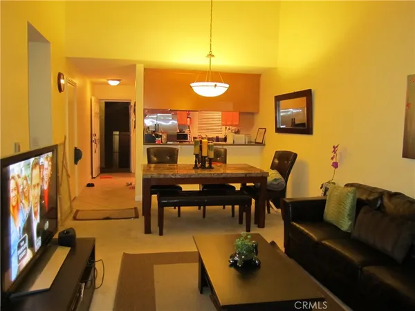 a view of a livingroom with furniture and a flat screen tv