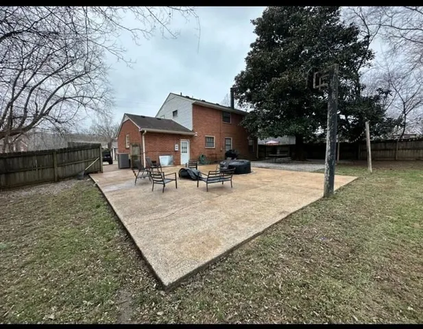 a view of a patio with table and chairs with wooden fence and floor