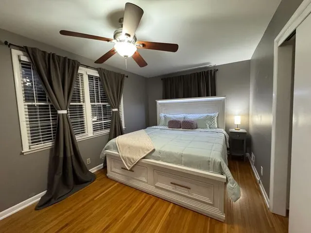 a bedroom with a large bed and a chandelier