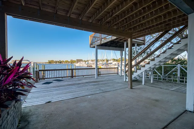 a view of a chairs and table on the wooden roof deck