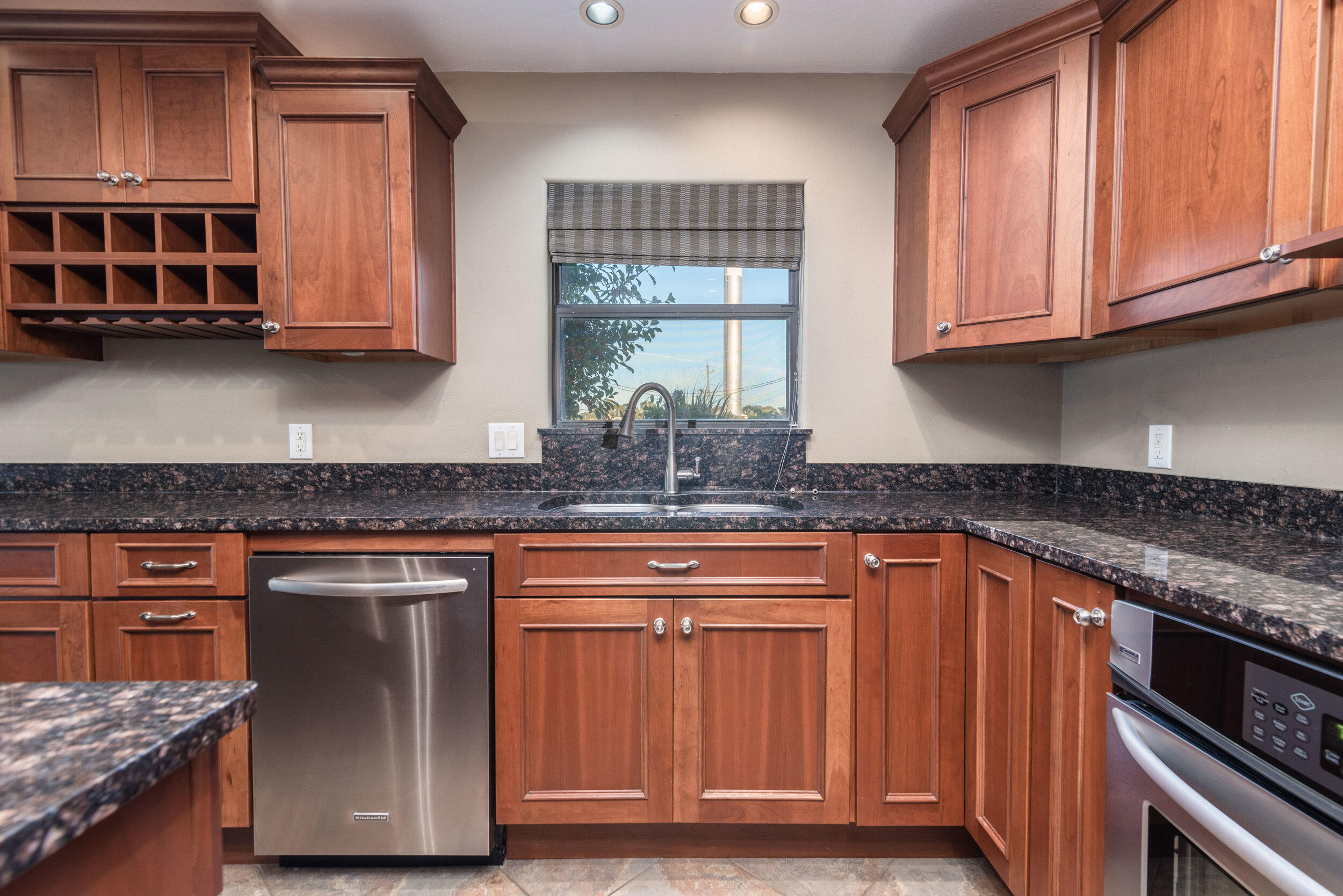 202 Snug Harbour Drive, Unit 202 Shalimar, FL 32579 - Photo 24 of 65 a kitchen with stainless steel appliances granite countertop a stove a sink and a microwave