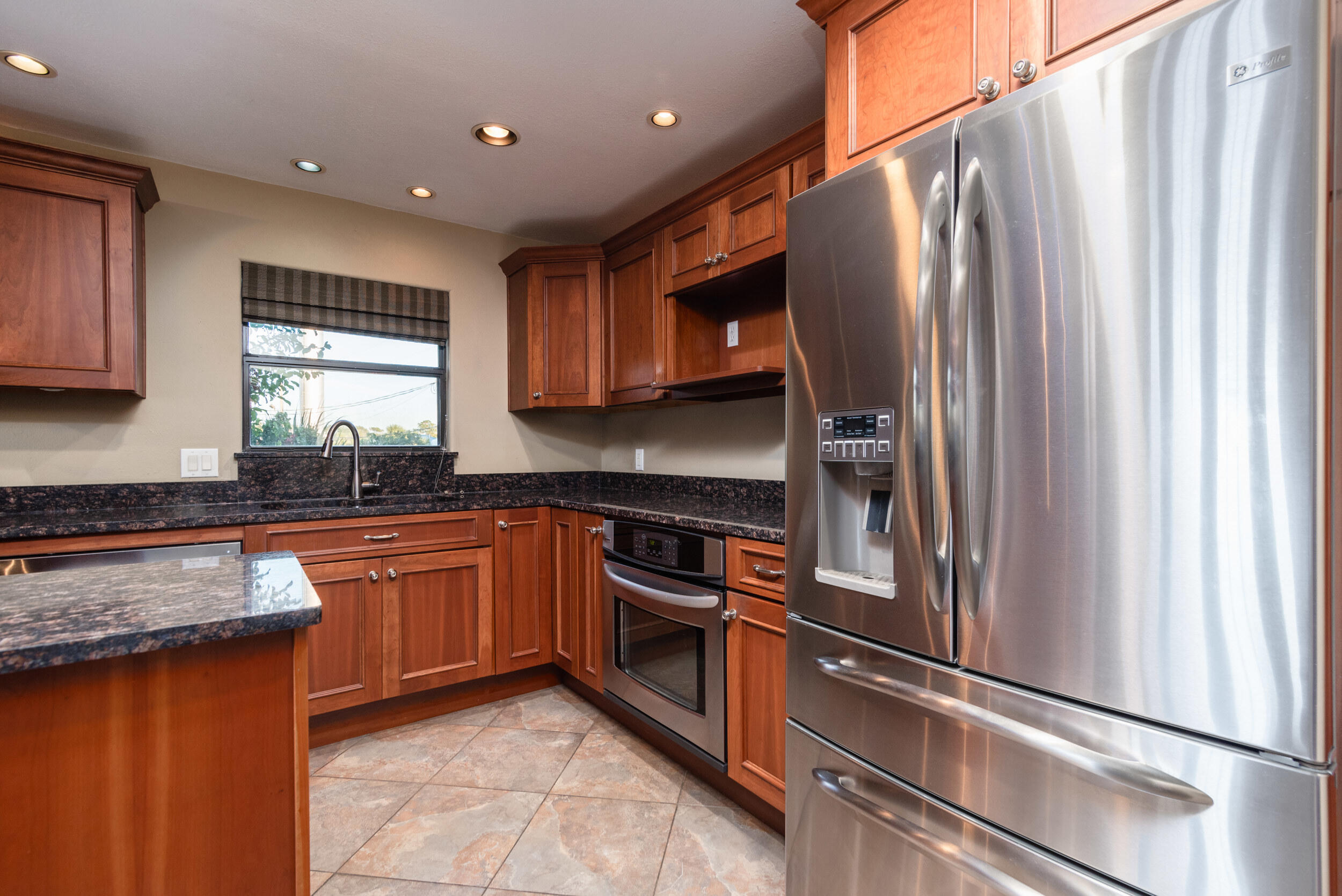202 Snug Harbour Drive, Unit 202 Shalimar, FL 32579 - Photo 25 of 65 a kitchen with stainless steel appliances granite countertop a refrigerator a sink dishwasher a stove and white countertops with wooden floor