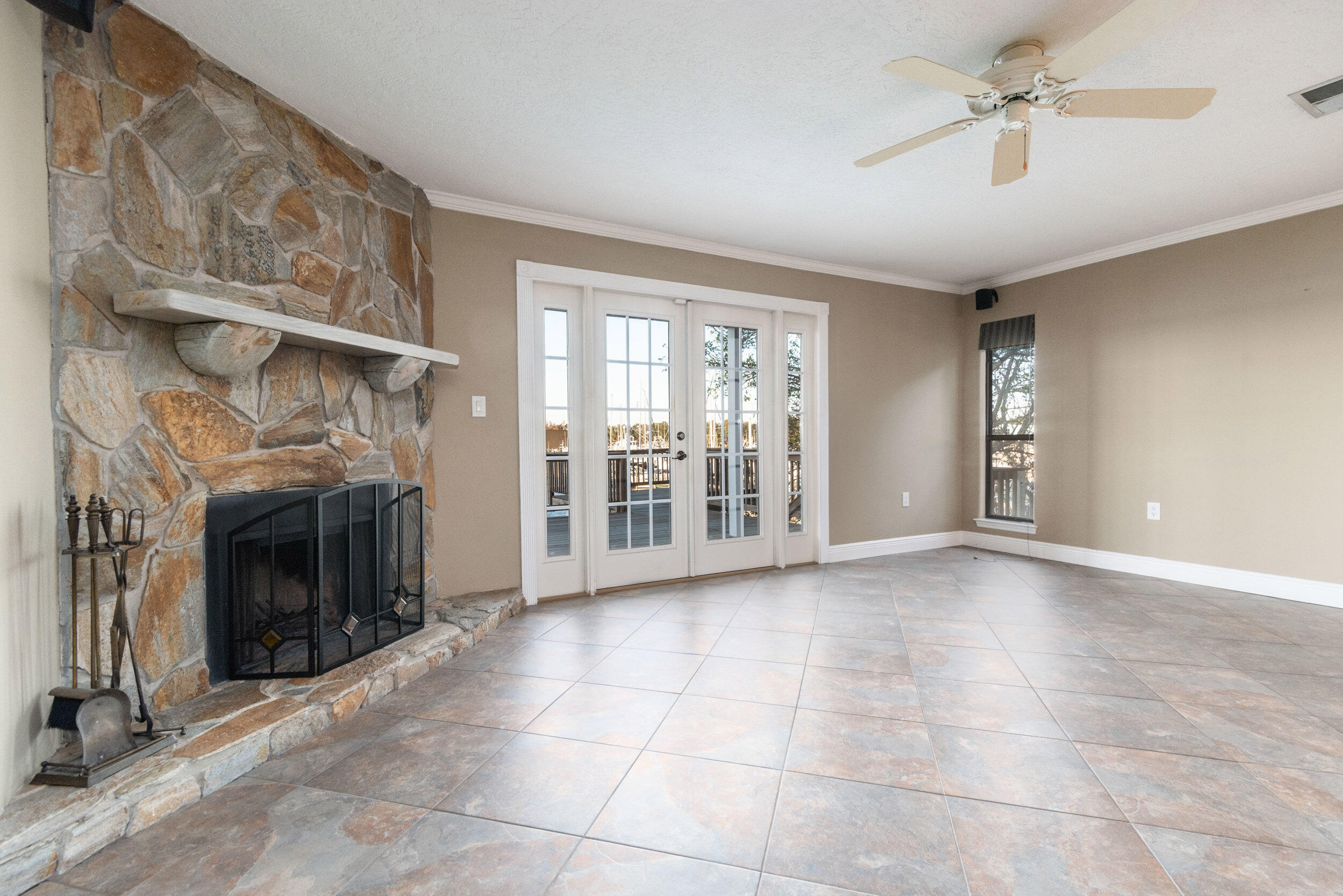 202 Snug Harbour Drive, Unit 202 Shalimar, FL 32579 - Photo 27 of 65 a view of an empty room with a fireplace and a window