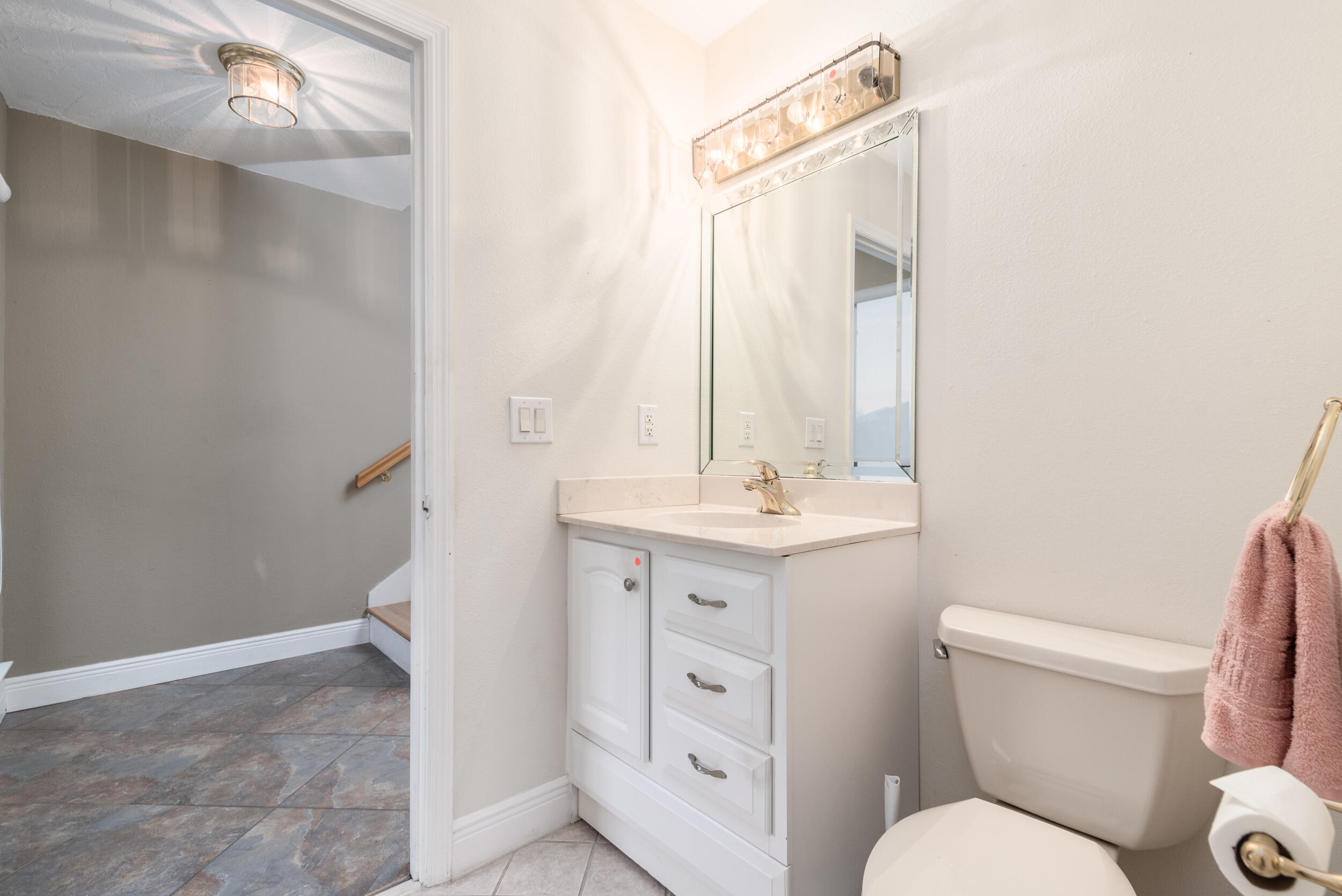 202 Snug Harbour Drive, Unit 202 Shalimar, FL 32579 - Photo 34 of 65 a bathroom with a toilet a sink and a mirror