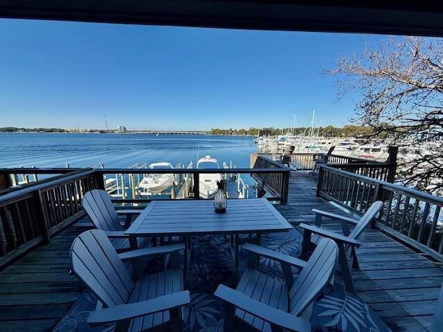 202 Snug Harbour Drive, Unit 202 Shalimar, FL 32579 - Photo 64 of 65 a view of a roof deck with table and chairs a barbeque with wooden floor and fence