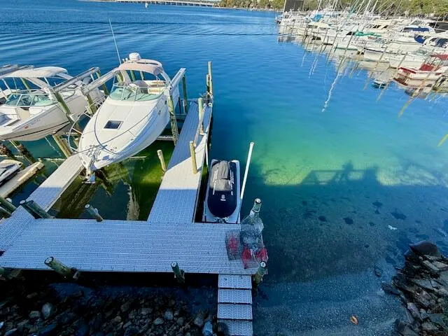 a view of staircase with lots of frames on wall and a window